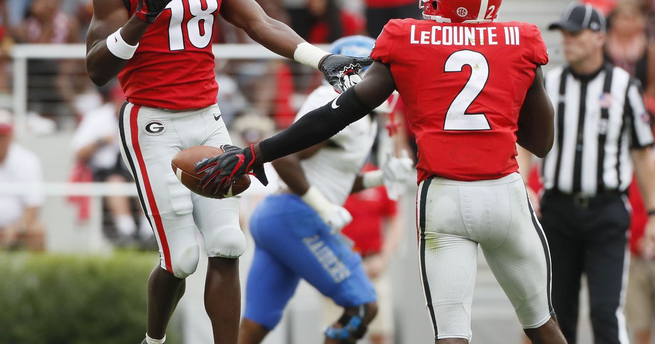 Georgia Bulldogs defensive back Deandre Baker (18) gegs flagged for  excessive celebration after intercepting an Alabama pass in the third  quarter of the NCAA College Football Playoff National Championship at  Mercedes-Benz Stadium