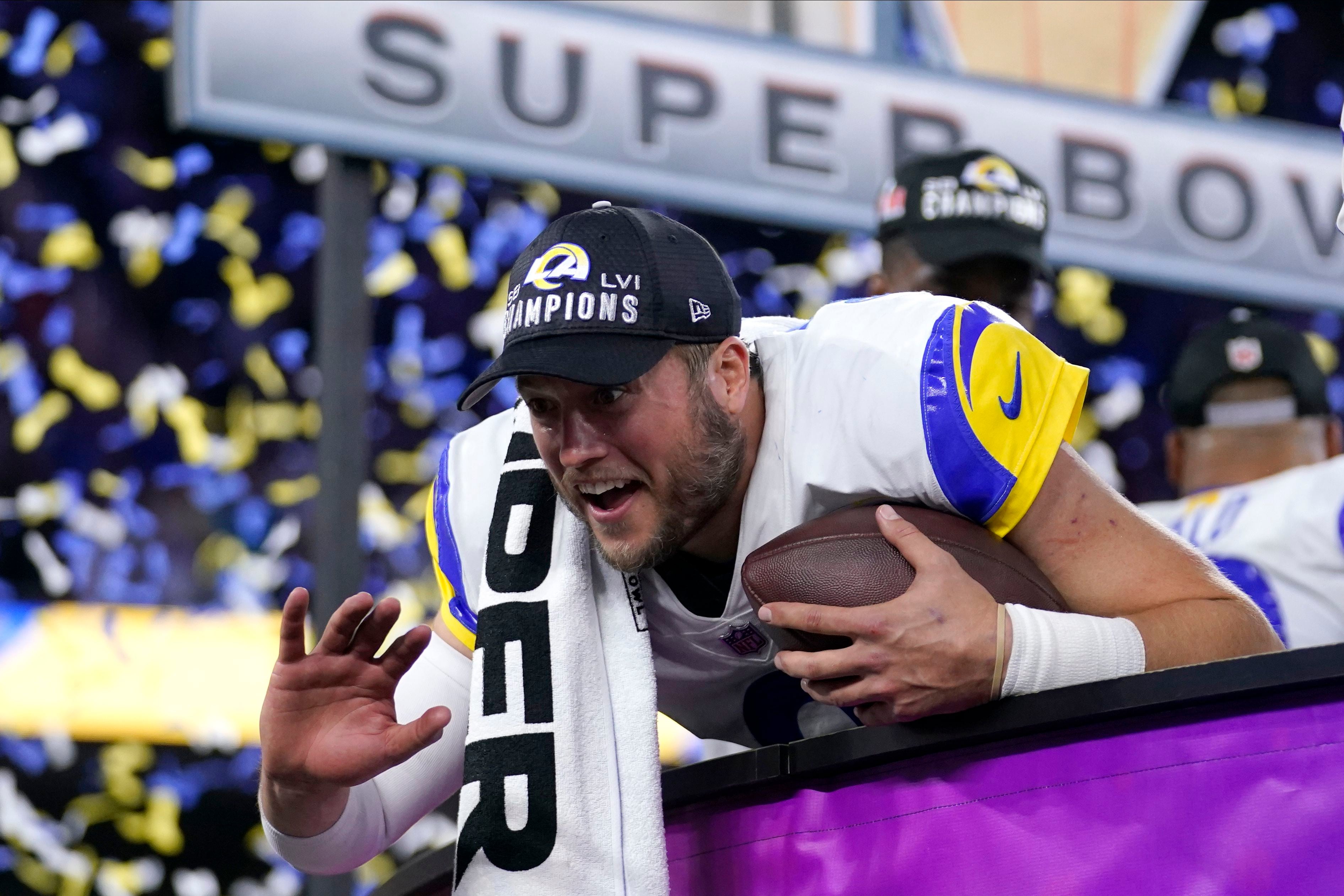 Georgia quarterback Matthew Stafford walks down an isle holding a