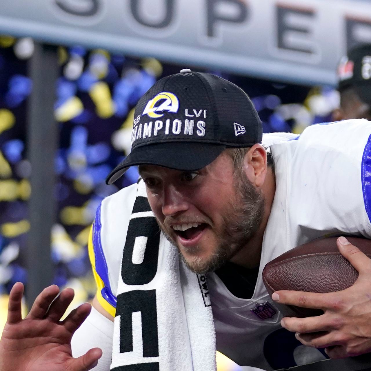 Georgia quarterback Matthew Stafford walks down an isle holding a