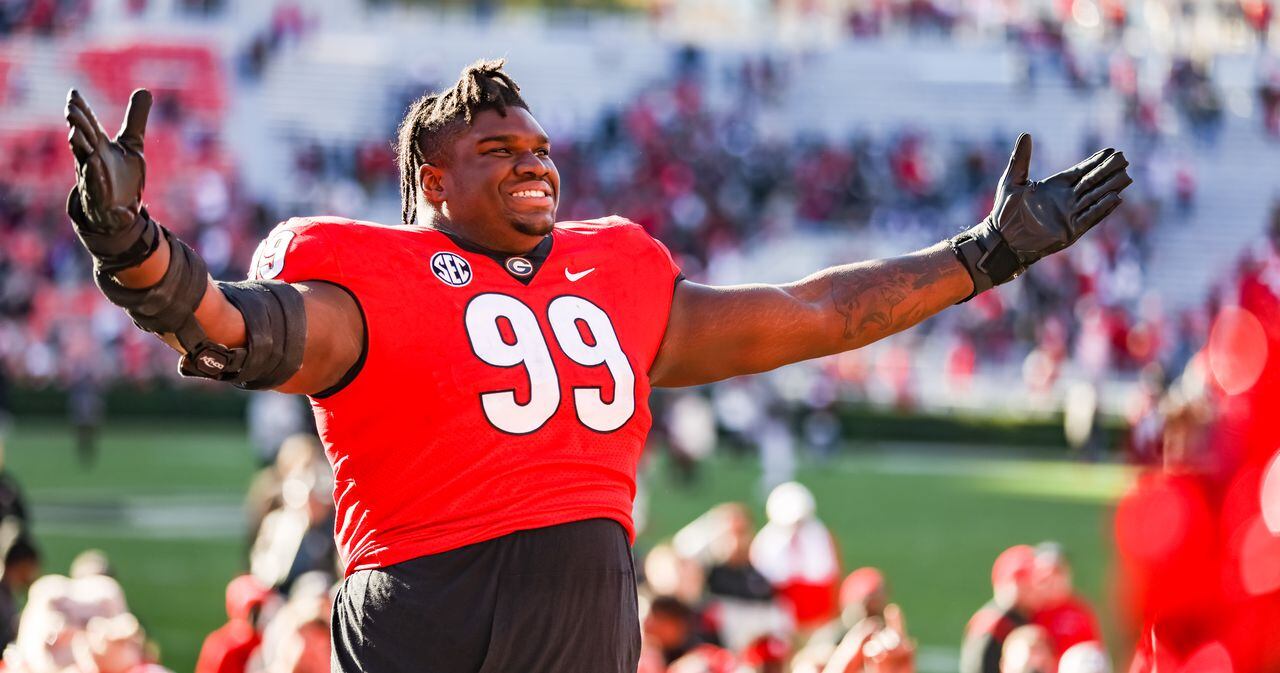 Georgia Bulldogs defensive lineman Jordan Davis (99) celebrating during the  trophy presentation of the 2022 CFP college football national championship  game at Lucas Oil Stadium, Monday, Jan. 10, 2022, in Indianapolis. Georgia