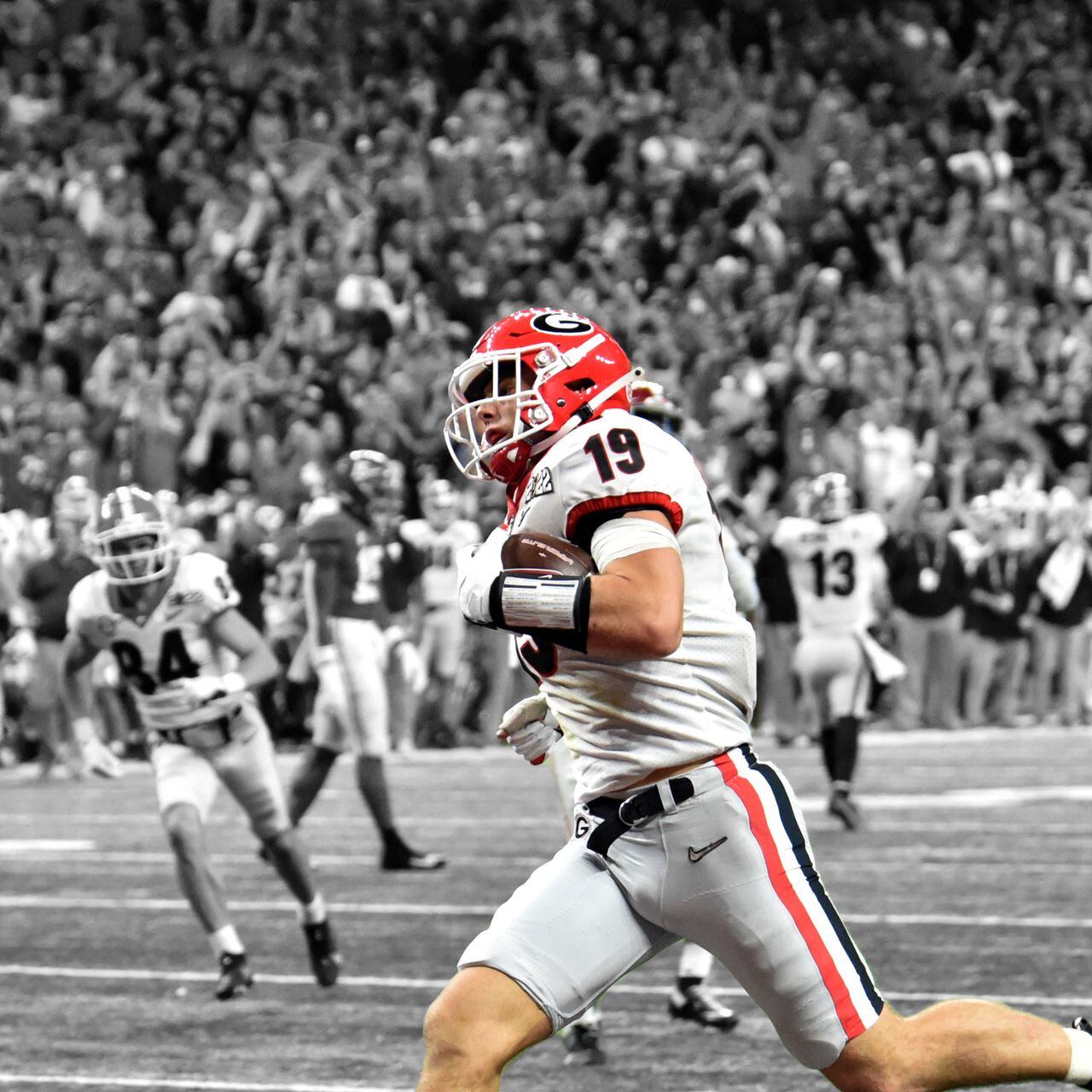 FILE - Georgia tight end Brock Bowers (19) makes a touchdown catch over TCU  safety Abraham Camara (14) during the second half of the national  championship NCAA College Football Playoff game, Monday